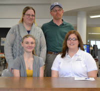 Joli Garbers of Central City with Coach Higgins and parents